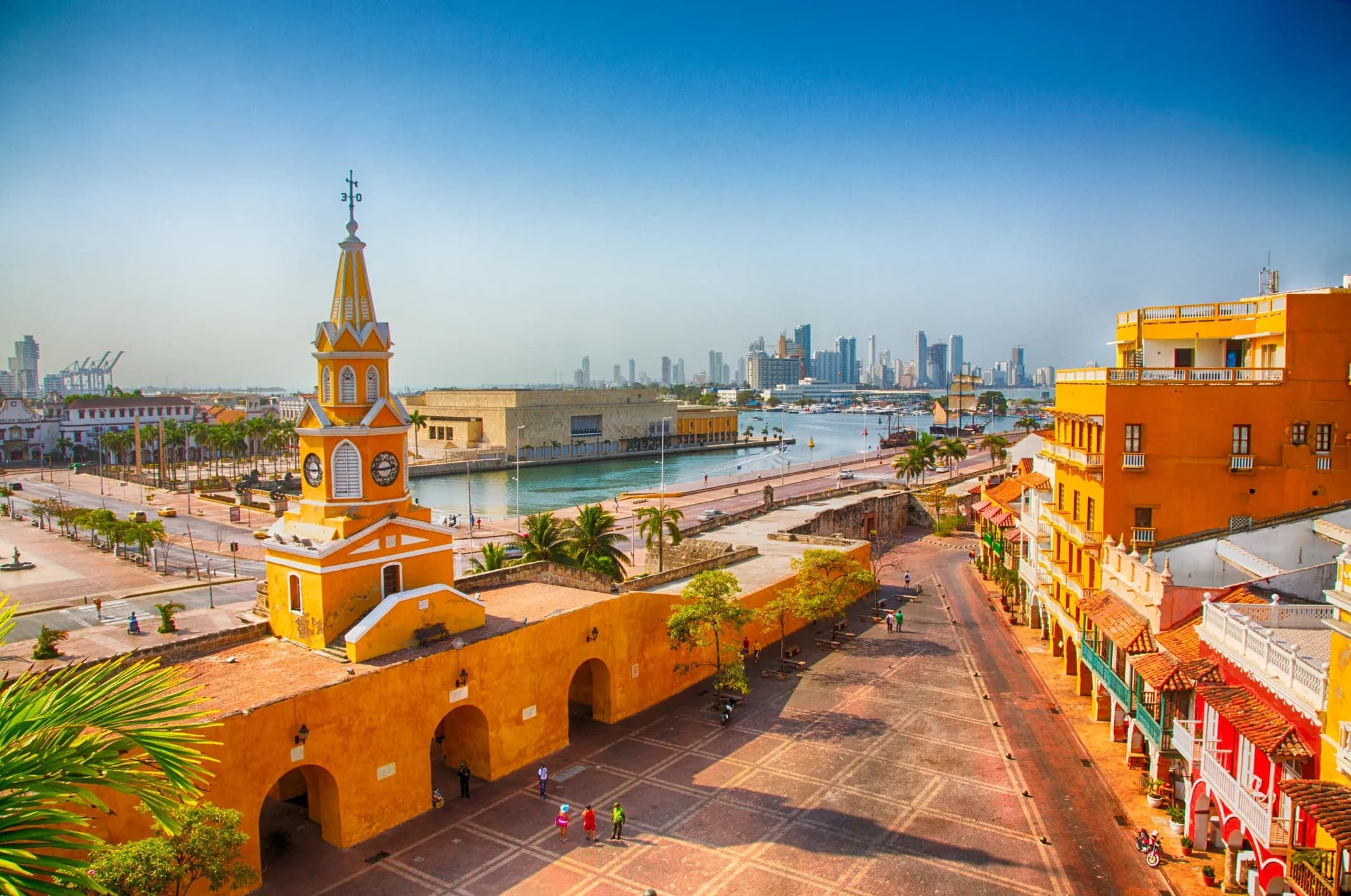 Vista aerea de la Puerta del Reloj de Cartagena con edificios coloniales coloridos y horizonte moderno al fondo